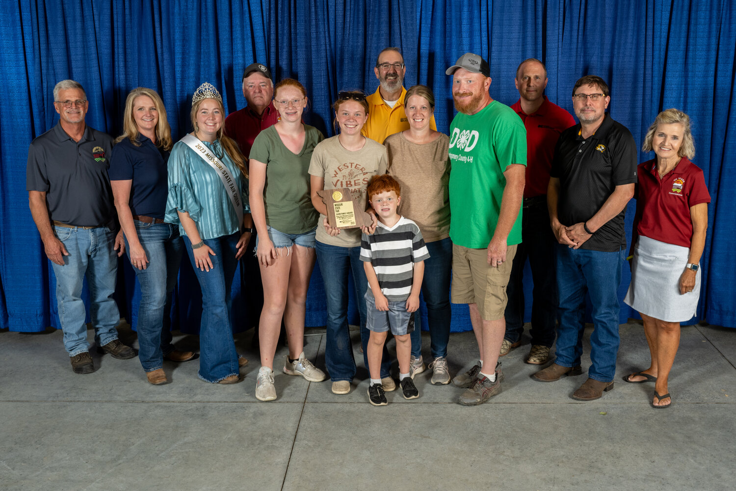 The VanBooven family was chosen as the Missouri Farm Family for Montgomery County. Pictured are, front row from left, Andrea VanBooven, Victoria VanBooven, Gus VanBooven, Melissa VanBooven and Jim VanBooven. Back row are Mark Wolfe, Missouri State Fair Director; Christine Chinn, Director, Missouri Department of Agriculture; Kelsey Miller, Missouri State Fair Queen; Ted E. Sheppard, Missouri State Fair Commissioner; Chad Higgins, Interim Vice Chancellor for MU Extension and Engagement and Interim Chief Engagement Officer, UM System; Garrett Hawkins, President, Missouri Farm Bureau; Harold “Byron” Roach, Missouri State Fair Commissioner; Rob Kallenbach, MU Associate Dean of Extension and Senior Program Director of Agriculture and Environment; and Nikki Cunningham. Missouri State Fair Commissioner.