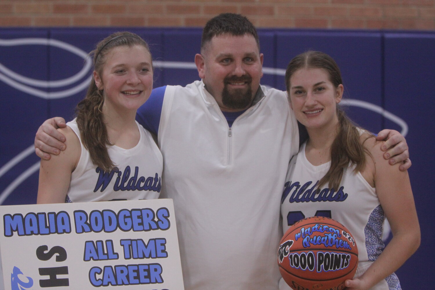 Montgomery County seniors Malia Rodgers and Maddy Queathem pose with coach Joe Basinger after the Wildcats defeated Van-Far on Tuesday. Rodgers broke the all-time career scoring record, while Queathem hit the 1,000-point mark.