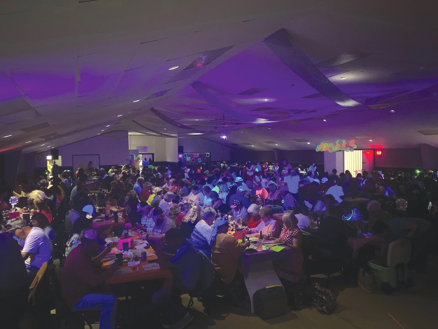 Participants enjoy last year’s Blacklight Bingo and Taco Bar at the Montgomery County Fairgrounds Merchants Building. The event returns for its second year on Feb. 9-10.