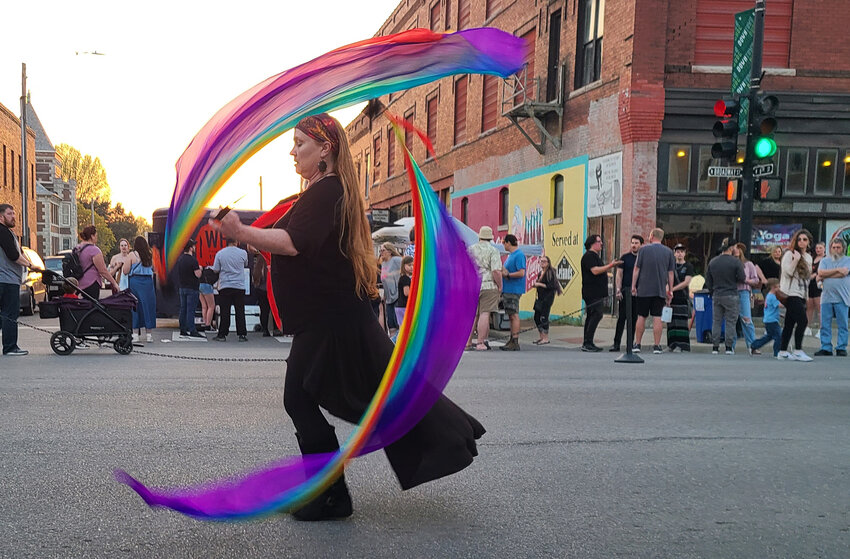 Lastacia Ross twirls fabric poi in the evening during the Pittsburg ArtWalk. Performances during the arts festival included fire poi, baton twirling, belly dancing and more.