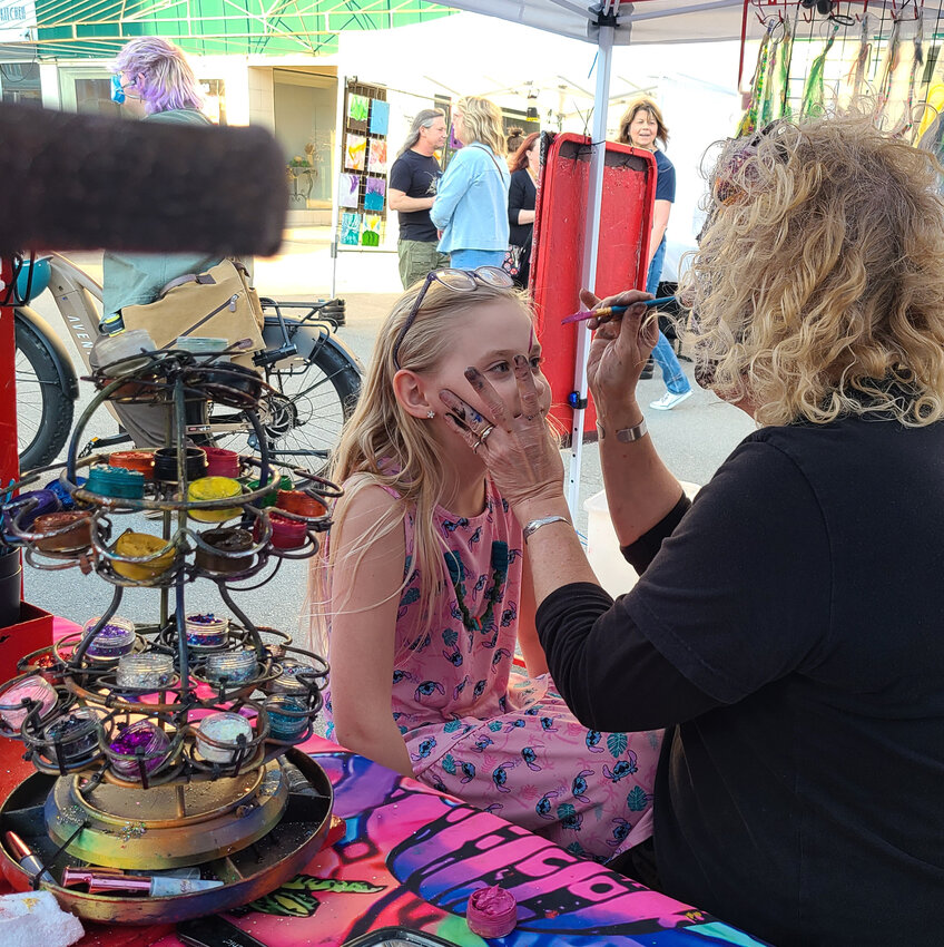 8-year-old Aurora Dennis, of Weir, gets her face painted by Angela Swift of Artistic Impressions by Angela on April 12. People of all ages requested face paintings from Swift during the Pittsburg ArtWalk.