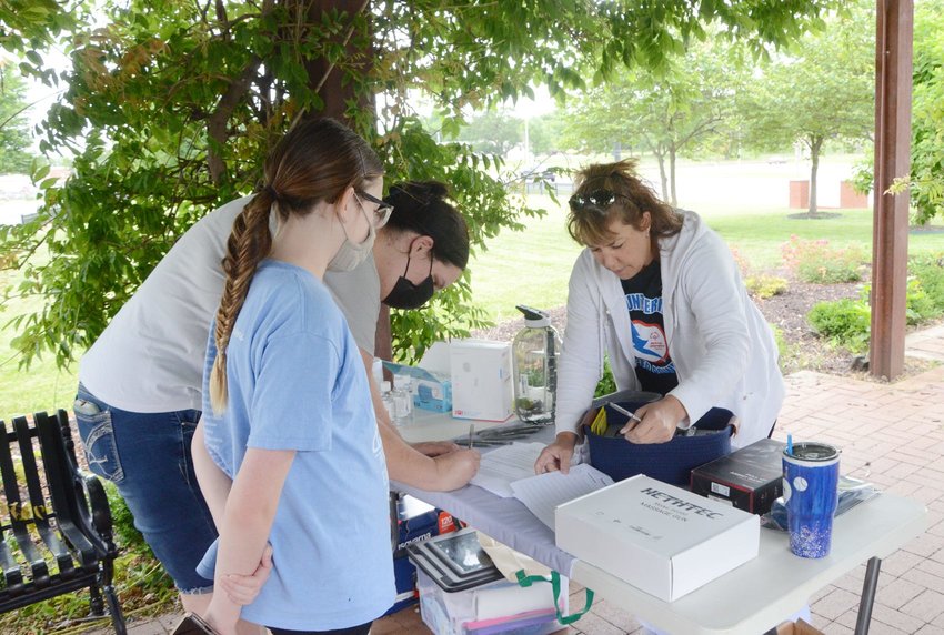 Tera Krantz and her daughter Chloe Riska sign up for the Special Olympics Kansas Treats and Trails event on Wednesday, June 23.