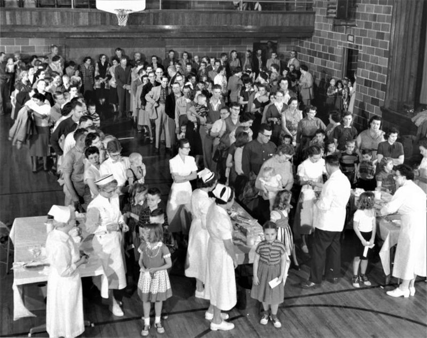 Residents of Protection, Kansas gather in the high school gym to receive the polio vaccine in 1957.