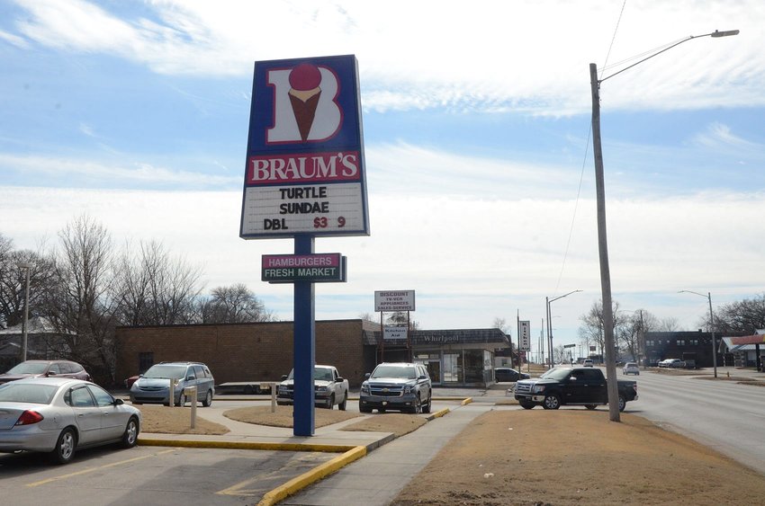 A customer pulls into the parking lot at Braum's on South Broadway in Pittsburg. Braum's is located just north of a vacant building (in background) that the City of Pittsburg, which owns the property, has approved for demolition.