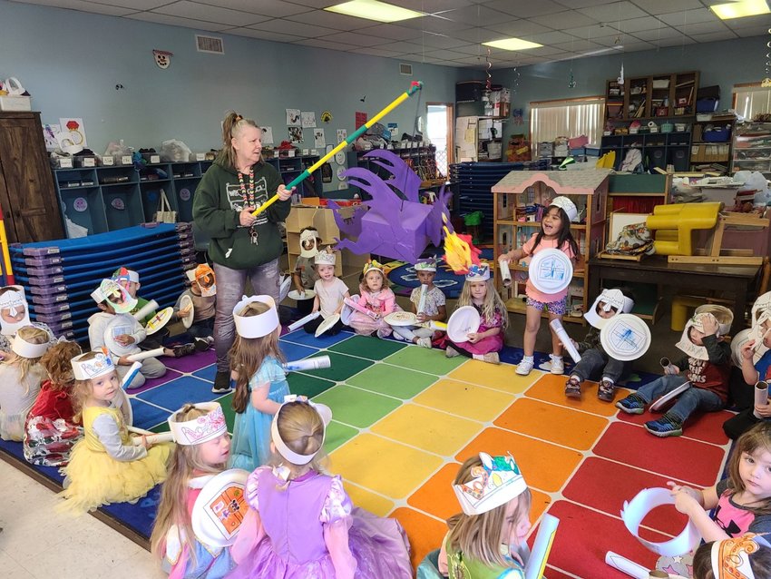 Children battle a cardboard dragon dressed as knights and princesses at Pittsburg Community Child Care Learning Center&rsquo;s 50th anniversary celebration.
