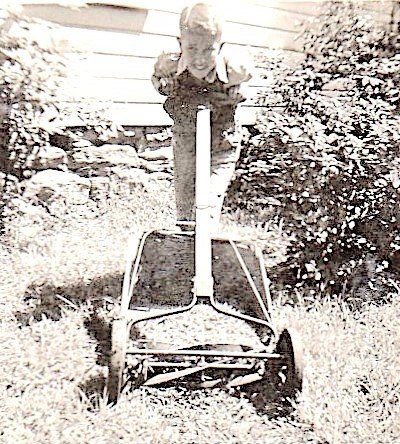 Dickie cutting grass, 1950.