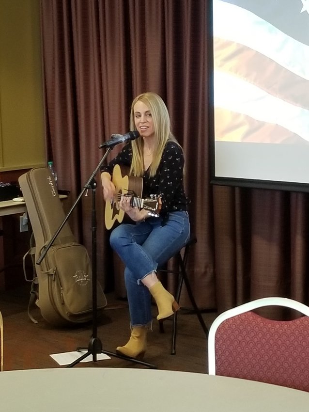 Jenn Schott, a Pittsburg native and songwriter in Nashville, performs for the Pittsburg Noon Rotary Club during its meeting on March 29.