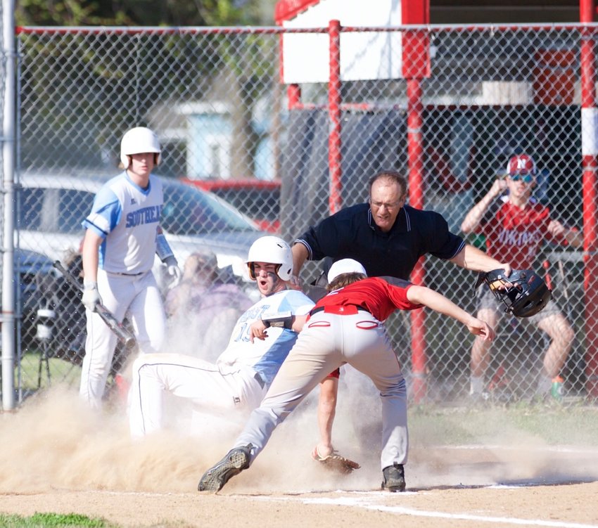 Southeast&rsquo;s Nate Jacobs evades a tag by Northeast&rsquo;s Braden Young and is called safe.
