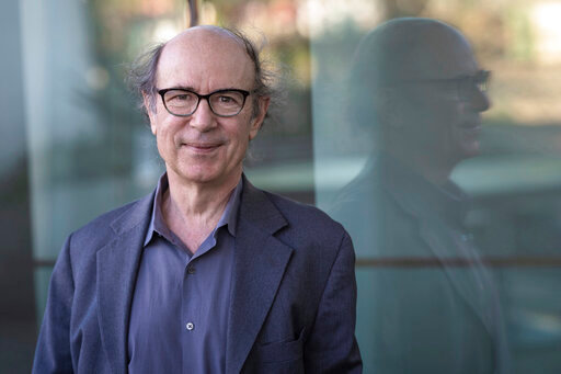 In this photo provided by the Templeton Prize, physicist Frank Wilczek stands for a portrait at Arizona State University in Tempe, Ariz., on March 17, 2022. Wilczek, the Nobel Prize-winning theoretical physicist and author renowned for his boundary-pushing investigations into the fundamental laws of nature, was honored&nbsp;Wednesday, May 11, 2022,&nbsp;with the Templeton Prize, awarded to individuals whose life&rsquo;s work embodies a fusion of science and spirituality. (Michael Clark via AP)