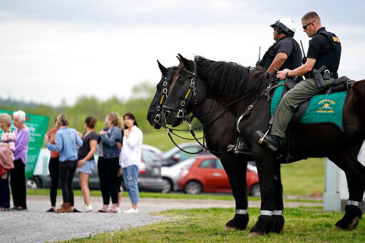 FILE -Officers on horseback guard the entrance to designated demonstrator areas near Riverbend Maximum Security Institution as people wait to enter before the scheduled execution of inmate Oscar Smith, Thursday, April 21, 2022, in Nashville, Tenn. Newly released records show at two least two people connected to a planned Tennessee execution that was abruptly put on hold April 21 knew the night before that the lethal injection drugs the state planned to use hadn&rsquo;t undergone certain required testing.  Last month, Gov. Bill Lee abruptly halted inmate Oscar Smith&rsquo;s execution, citing  an &ldquo;oversight&rdquo; in the execution process. (AP Photo/Mark Humphrey, File)