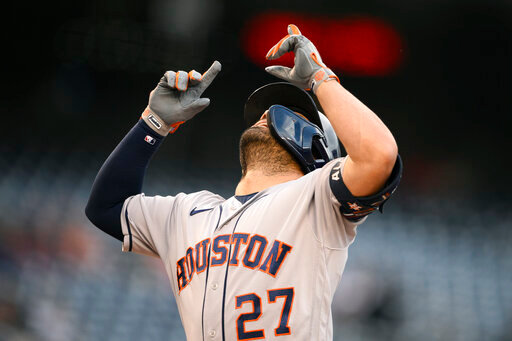 Houston Astros' Jose Altuve celebrates after his home run during the first inning of a baseball game against the Washington Nationals, Friday, May 13, 2022, in Washington. (AP Photo/Nick Wass)