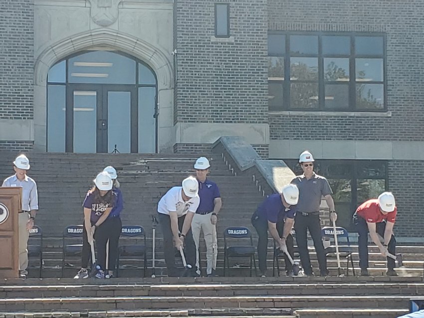 School officials and project stakeholders swing sledgehammers against the front steps of Pittsburg Community Middle School, marking the official start of renovations to the historic building on Monday.&nbsp;Pictured are, from left, Blake Benson, president of the Pittsburg Area Chamber of Commerce; Dr. Amy Bartlett, sixth grade math teacher; Laura Earl, principal of PCMS; Dr. Micky Painter, president of USD 250 school board; Richard Proffitt, USD 250 superintendent; Dr. Brad Hansen, USD 250 assistant superintendent; Michael Wischmeyer, Corner-Greer Architecture; and David Dikeman, McCowan-Gordon Construction.
