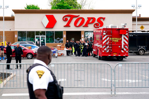 Investigators work the scene of a shooting at a supermarket, in Buffalo, N.Y., Monday, May 16, 2022. While law enforcement officials have grown adept since the Sept. 11 attacks at disrupting well-organized plots, they face a much tougher challenge in intercepting self-radicalized young men who absorb racist screeds on social media and plot violence on their own.  (AP Photo/Matt Rourke)