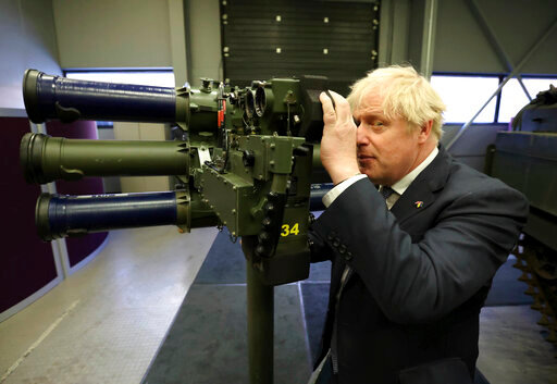 Britain's Prime Minister Boris Johnson with a Mark 3 shoulder launch LML (Lightweight Multiple Launcher) missile system, at Thales weapons manufacturer in Belfast, Monday May 16, 2022, during a visit to Northern Ireland. Johnson said there would be &ldquo;a necessity to act&rdquo; if the EU doesn't agree to overhaul post-Brexit trade rules that he says are destabilizing Northern Ireland's delicate political balance. Johnson held private talks with the leaders of Northern Ireland's main political parties, urging them to get back to work. (Liam McBurney/Pool via AP)