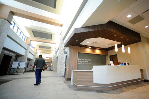 A man walks through the lobby of Thomasville Regional Medical Center in Thomasville, Ala., on Tuesday, May 3, 2022. The hospital is among three in the nation that say they are missing out on federal pandemic relief money because they opened during or shortly before the COVID-19 crisis began. (AP Photo/Jay Reeves)