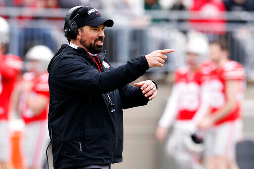 FILE - Ohio State head coach Ryan Day directs his team during an NCAA college spring football game on April 16, 2022, in Columbus, Ohio. Ohio State is hiking Day's annual salary to $9.5 million, as part of a two-year contract extension that will put him among the nation's highest-paid college football coaches.  (AP Photo/Jay LaPrete, File)