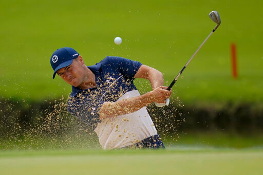 Jordan Spieth hits from the bunker on the 13th hole during a practice round for the PGA Championship golf tournament, Tuesday, May 17, 2022, in Tulsa, Okla. (AP Photo/Sue Ogrocki)