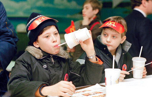 FILE - Young Muscovites checks out a new taste sensation for the Soviet Union, hamburgers and soft drinks in Moscow on Jan. 31, 1990.  McDonald&rsquo;s said Thursday, May 19, 2022, it has begun the process of selling its Russian business to one of its licensees in the country. The Chicago burger giant said Alexander Govor, who operates 25 restaurants in Siberia, has agreed to buy McDonald&rsquo;s 850 Russian restaurants and operate them under a new brand. McDonald&rsquo;s didn&rsquo;t disclose the sale price. (AP Photo/Rudi Blaha, File)