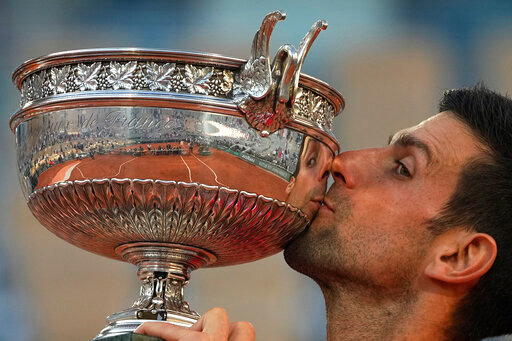 FILE - Serbia's Novak Djokovic kisses the cup after defeating Stefanos Tsitsipas of Greece during their final match of the French Open tennis tournament at the Roland Garros stadium, Sunday, June 13, 2021 in Paris. Djokovic won 6-7 (6), 2-6, 6-3, 6-2, 6-4. Rafael Nadal and Novak Djokovic are both entered in the French Open, making it the first Grand Slam tournament with both of them in the field since last year&rsquo;s French Open. (AP Photo/Michel Euler, File)