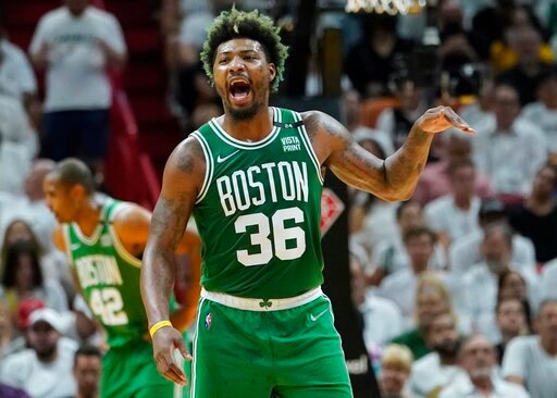 Boston Celtics guard Marcus Smart (36) gestures during the first half of Game 2 of the NBA basketball Eastern Conference finals playoff series against the Miami Heat, Thursday, May 19, 2022, in Miami. (AP Photo/Lynne Sladky)