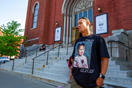 Enrique Owens, a cousin of Roberta Drury, wears a t-shirt with her photograph on it before her funeral service, Saturday, May 21, 2022, in Syracuse, N.Y. Drury was one of 10 killed during a mass shooting at a supermarket last week in Buffalo. (AP Photo/Lauren Petracca)