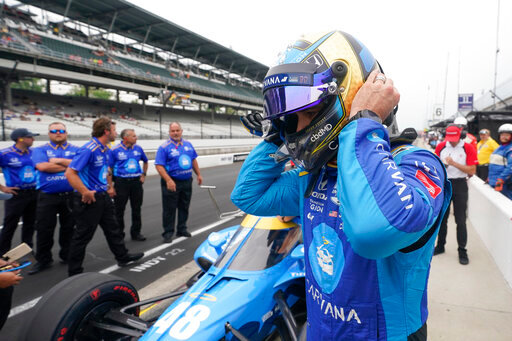 Jimmie Johnson takes off his helmet during qualifications for the Indianapolis 500 auto race at Indianapolis Motor Speedway, Saturday, May 21, 2022, in Indianapolis. (AP Photo/Darron Cummings)