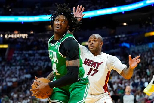 Boston Celtics center Robert Williams III (44) handles the ball as Miami Heat forward P.J. Tucker (17) defends during the first half of Game 2 of the NBA basketball Eastern Conference finals playoff series, Thursday, May 19, 2022, in Miami. (AP Photo/Lynne Sladky)