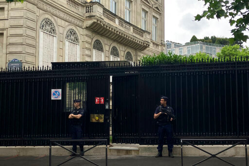 Police officers guard the entrance of the Qatar embassy, Monday, May 23, 2022 in Paris. An investigation for homicide was opened on Monday May 23, 2022 after a watchman at the Qatar Embassy in Paris was killed and a suspect arrested, the prosecutor's office said. The circumstances of the killing, including the method used, were not immediately clear. (AP Photo/Alexander Turnbull)