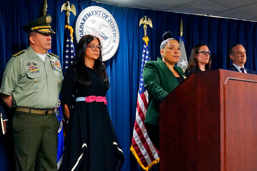 U.S. Attorney Rachael Rollins, of the Massachusetts District, center, addresses the media at the Moakley Federal Courthouse, Tuesday, May 24, 2022, in Boston. Nineteen people were indicted in a complex money laundering scheme to move millions of dollars in drug proceeds from Colombian cartels through U.S. banks. From left are Colombia National Police Major General Ricardo Augusto Alarcon Campos, Colombia Attorney General office delegate Luz Angela Bahamon Florez, Rollins, Internal Revenue Special Agent in Charge Joleen Simpson and Drug Enforcement Administration Special Agent in Charge Brian Boyle. (AP Photo/Charles Krupa)