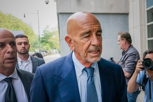 FILE - Tom Barrack, center, arrives at Brooklyn federal court, Monday, July 26, 2021, in New York. Federal prosecutors have spelled out more details of the allegations against Barrack, the chair of former President Donald Trump's inaugural committee, who's accused of secretly working as an agent for the United Arab Emirates to influence Trump's foreign policy. (AP Photo/Mark Lennihan, File)