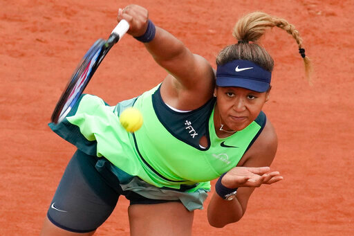 FILE - Japan's Naomi Osaka serves against Amanda Anisimova of the U.S. during their first round match at the French Open tennis tournament in Roland Garros stadium in Paris, France, Monday, May 23, 2022. Naomi Osaka's 2022 French Open is done following a first-round loss. The players remaining in the tournament see and hear products of her frank discussion about anxiety and depression a year ago -- from new &quot;quiet rooms&quot; and on-call psychiatrists at Roland Garros to a broader sense that mental health is a far-less-taboo topic than it once was. (AP Photo/Christophe Ena, File)