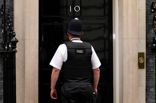 A police officer goes into 10 Downing Street, in London, Wednesday, May 25, 2022. British Prime Minister Johnson is awaiting a senior civil servant's report into lockdown-breaking government parties that could further weaken his grip on power. The results of senior civil servant Sue Gray's investigation of the &quot;partygate&quot; scandal could come as soon as Wednesday, and will pile more pressure on the prime minister. (AP Photo/Matt Dunham)
