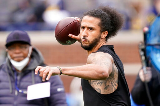 FILE- free agent quarterback Colin Kaepernick throws during halftime of an NCAA college football intrasquad spring game at Michigan, on April 2, 2022, in Ann Arbor, Mich. Kaepernick is getting his first chance to work out for an NFL team since last playing in the league in 2016 when he started kneeling during the national anthem to protest police brutality and racial inequality.  Two people familiar with the situation said on Wednesday, May 25, 2022, that Kaepernick will work out for the Las Vegas Raiders. (AP Photo/Carlos Osorio, File)