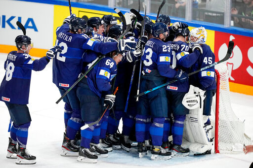 Team Finland celebrates victory after a match between Finland and the the United States in the semifinals of the Hockey World Championships, in Tampere, Finland, Saturday, May 28, 2022. Finland won 4-3. (AP Photo/Martin Meissner)