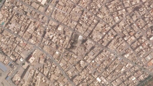 This satellite photo from Planet Labs PBC shows the Metropol Building collapse site, center, in Abadan, Iran, Thursday, May 26, 2022. Iranian riot police fired tear gas and shot into the air to disperse an angry crowd of hundreds of people near the site of the building collapse in the southwestern city of Abadan, online video analyzed Saturday, May 28, 2022, showed. (Planet Labs PBC via AP)