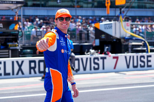 Scott Dixon, of New Zealand, walks to his car before the Indianapolis 500 auto race at Indianapolis Motor Speedway in Indianapolis, Sunday, May 29, 2022. (AP Photo/AJ Mast)