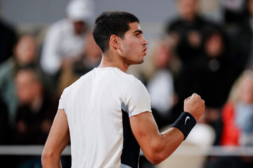 Spain's Carlos Alcaraz clenches his fist after scoring a point against Russia's Karen Khachanov during their fourth round match at the French Open tennis tournament in Roland Garros stadium in Paris, France, Sunday, May 29, 2022. (AP Photo/Thibault Camus)