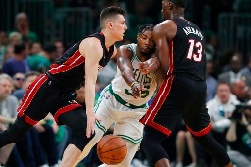 Miami Heat's Bam Adebayo (13) screens Boston Celtics' Marcus Smart (36) as Tyler Herro, left, drives   during the second half of Game 3 of the NBA basketball Eastern Conference finals playoff series, Saturday, May 21, 2022, in Boston. (AP Photo/Michael Dwyer)