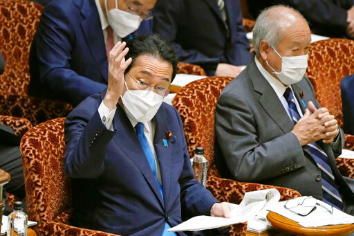 Japanese Prime Minister Fumio Kishida raises hand to speak at Budget Committee of the upper house of the Diet, Tuesday May 31, 2022 in Tokyo. Japan&rsquo;s parliament on Tuesday enacted a 2.7 trillion yen ($21 billion) extra budget to tackle soaring fuel and food prices following Russian invasion of Ukraine. (Kyodo News via AP)