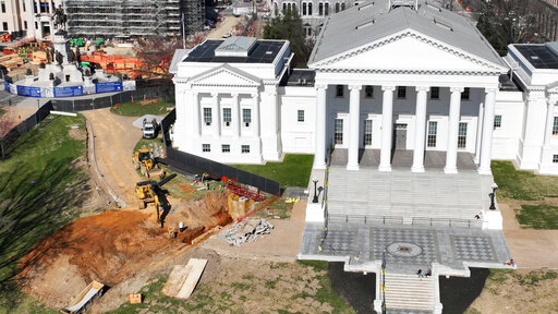 FILE - Workers begin digging a tunnel to connect the new General Assembly building to the Capitol, March 2, 2022, in Richmond, Va. Dena Potter, a spokeswoman for the state agency overseeing the project, said the Capitol was briefly evacuated on March 14, 2022, after a contractor working on the $25 million tunnel &ldquo;inadvertently&rdquo; poked through the ceiling of a subterranean Capitol extension causing debris to fall into the visitors center cafe. (AP Photo/Steve Helber, File)