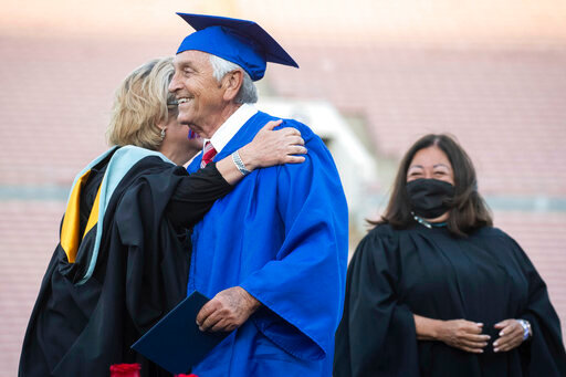 Ted Sams, 78, receives his original high school diploma during San Gabriel High School's graduation at the Rose Bowl on Friday, May 27, 2022, in Pasadena, Calif. (Sarah Reingewirtz/The Orange County Register via AP)