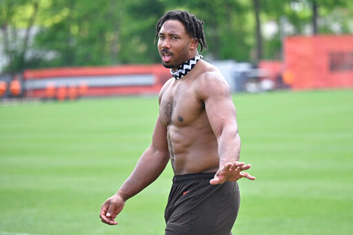 Cleveland Browns defensive end Myles Garrett walks on the field after an NFL football practice at the team's training facility, Wednesday, June 1, 2022, in Berea, Ohio. (AP Photo/David Richard)