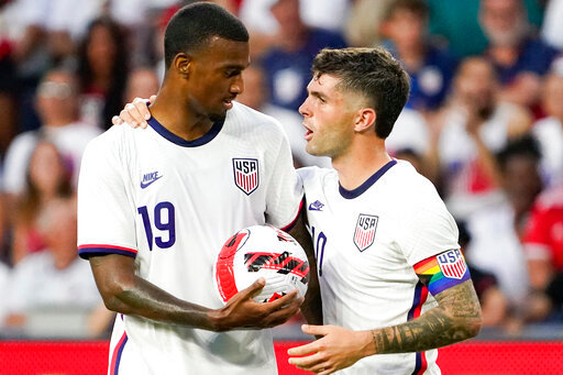 U.S. forward Christian Pulisic, right, hands the ball to Haji Wright (19) prior to a penalty kick during the second half of the team' international friendly soccer match against Morocco on Wednesday, June 1, 2022, in Cincinnati. (AP Photo/Jeff Dean)