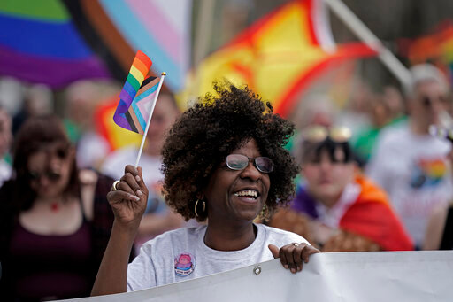Teresa Parks walks in the Little Apple Pride parade Saturday, April 23, 2022, in Manhattan, Kan. Inspired by protests following the death of George Floyd, parks co-founded a Black Lives Matter group and as part of a task force has pushed for more inclusion for people from diverse backgrounds in the predominantly white community. (AP Photo/Charlie Riedel)
