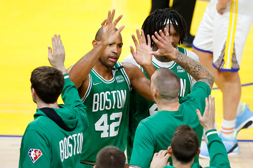 Boston Celtics center Al Horford (42) celebrates with teammates during the second half of Game 1 of basketball's NBA Finals against the Golden State Warriors in San Francisco, Thursday, June 2, 2022. (AP Photo/John Hefti)