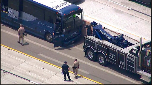 In this image from video provided by ABC7 Los Angeles, emergency personnel work at the site of a Greyhound bus crash after they blew a tire and weird into a sports utility vehicle and a center divider while heading from Los Angeles to Phoenix on INterste 10 on Friday, June 3, 2022. California Highway Patrol Officer Jason Montez says there were 33 people aboard the bus when it crashed in Banning, about 90 miles east of Los Angeles. (ABC7 Los Angeles via AP)