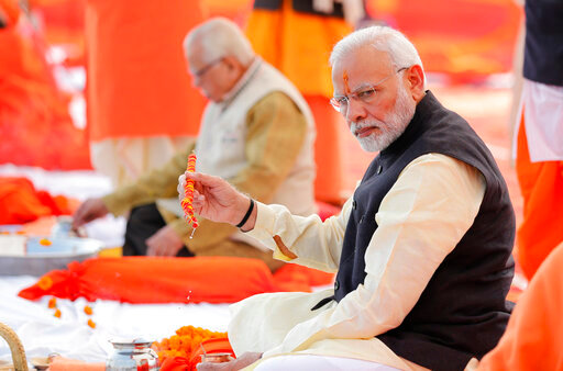 FILE- Indian Prime Minister Narendra Modi, front, performs Hindu rituals sitting at Sangam, the confluence of the Rivers Ganges and Yamuna, at Allahabad, India, Dec. 16, 2018. India is facing major diplomatic outrage from Muslim countries after top officials in the ruling Hindu nationalist party made derogatory references to Islam and the Prophet, drawing accusations of blasphemy across some Arab nations that have left New Delhi struggling to contain the damaging fallout. (AP Photo/Rajesh Kumar Singh, File)
