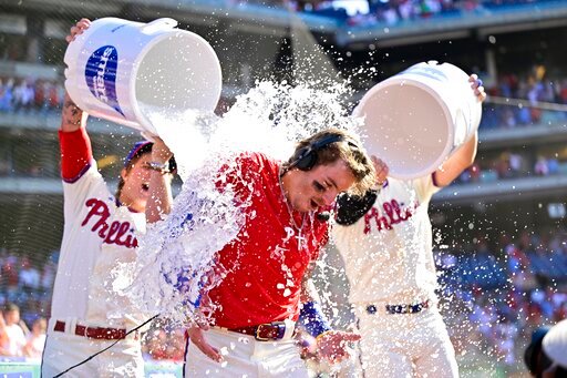Philadelphia Phillies' Bryson Stott is doused by teammates after hitting a walk-off three run home run during the ninth inning of a baseball game off Los Angeles Angels' Jimmy Herget, Sunday, June 5, 2022, in Philadelphia. (AP Photo/Derik Hamilton)