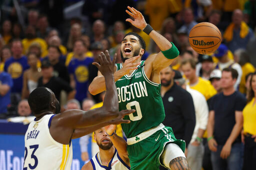 CORRECTS FROM GAME 1 TO GAME 2 - Boston Celtics forward Jayson Tatum (0) loses the ball while being defended by Golden State Warriors forward Draymond Green (23) and guard Stephen Curry during the second half of Game 2 of basketball's NBA Finals in San Francisco, Sunday, June 5, 2022. (AP Photo/Jed Jacobsohn)