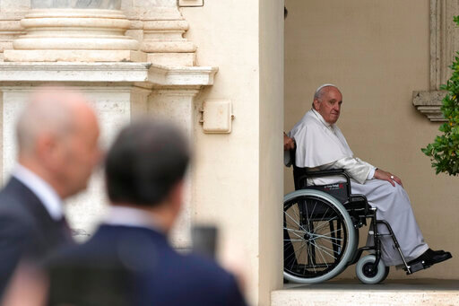 FILE - Pope Francis arrives on a wheelchair for an audience with children in the San Damaso courtyard at the Vatican, Saturday, June 4, 2022. Pope Francis added fuel to rumors about the future of his pontificate on Saturday by announcing he would visit the central Italian city of L'Aquila in August for a feast initiated by Pope Celestine V, one of the few pontiffs who resigned before Pope Benedict XVI stepped down in 2013. (AP Photo/Alessandra Tarantino, File)